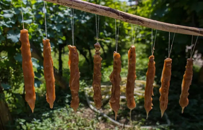 Churchkhela - grape and nut dried on string in sun